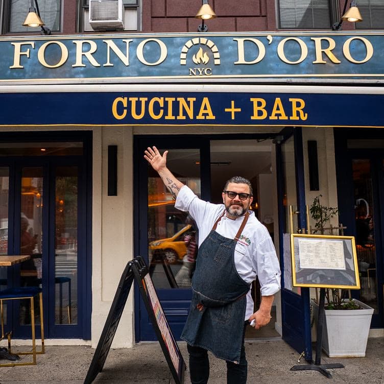 Salvatore waving at the door of Forno d'Oro