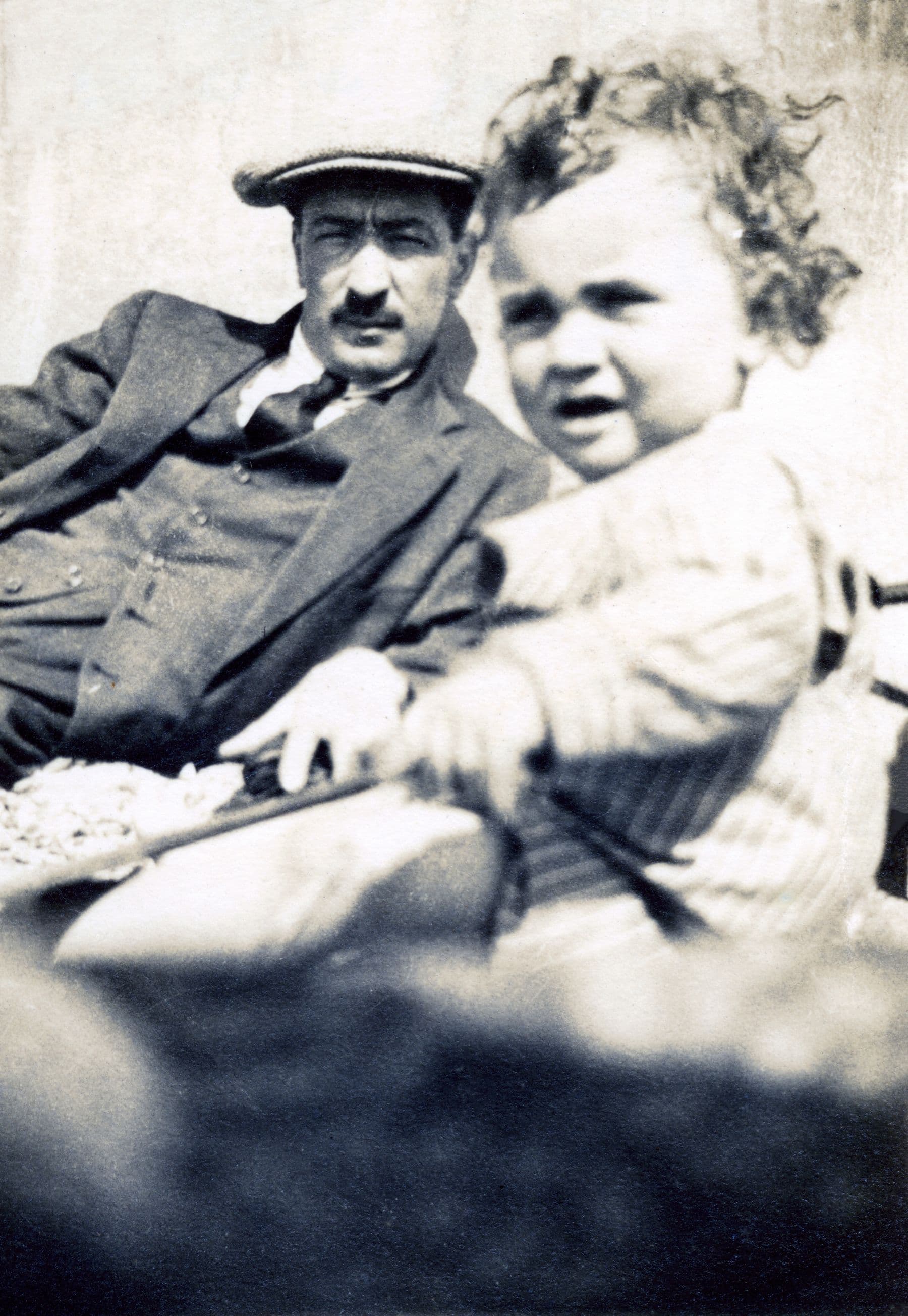 Old black and white photo of a man with a child