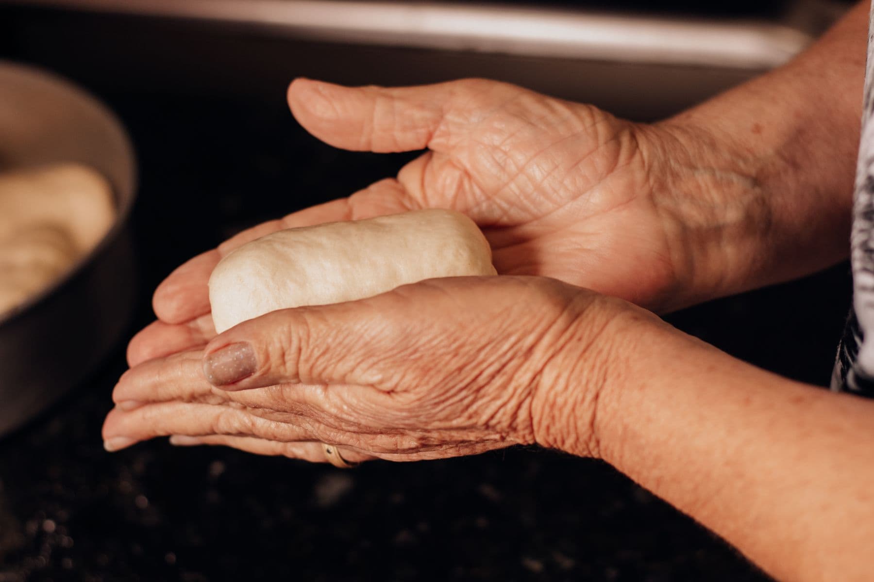 Old hands shaping dough